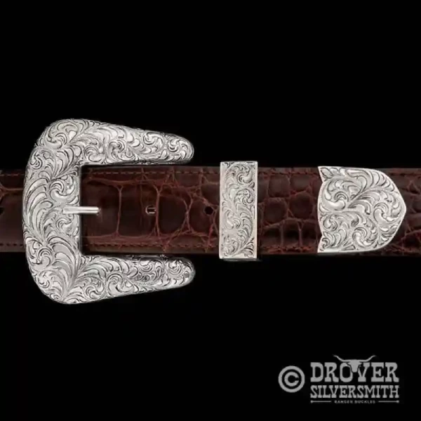 Introducing The Cowpoke Sterling Silver Belt Buckle, a durable hand engraved buckle set detailed with a classy antiqued finish and a refined touch of color. Add a second loop for a ranger buckle set now!